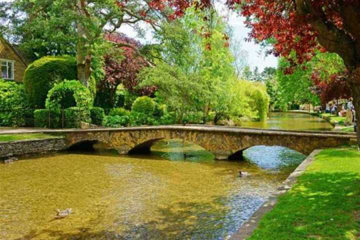a train crossing a bridge over a body of water
