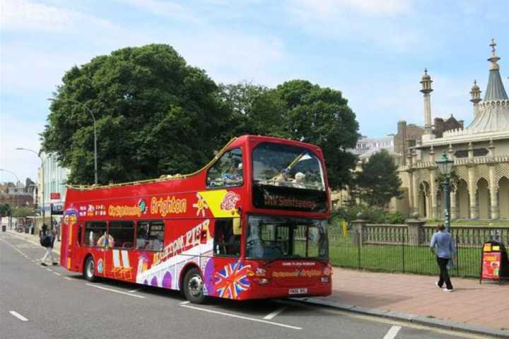 a double decker bus driving down a street
