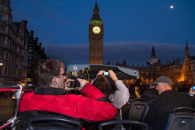 a clock tower in front of a crowd