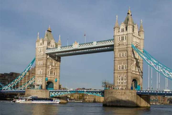 a large bridge over some water in front of a building