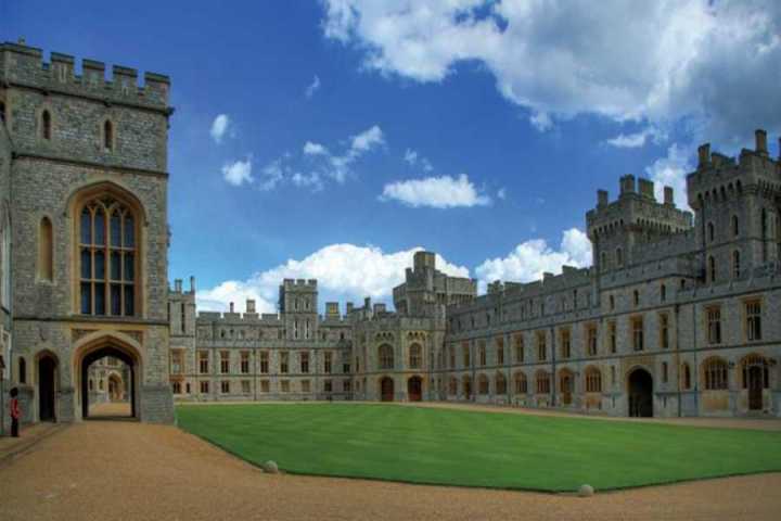 a castle with a clock tower in front of a building