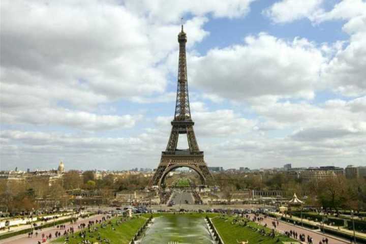 a large clock tower towering over Eiffel Tower