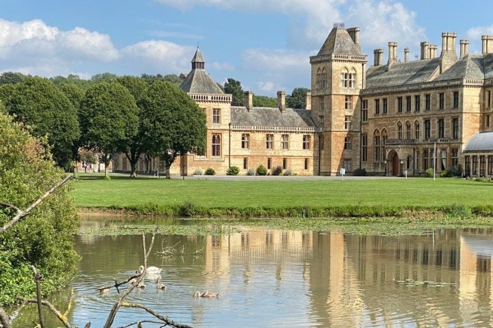 a castle with water in front of a lake