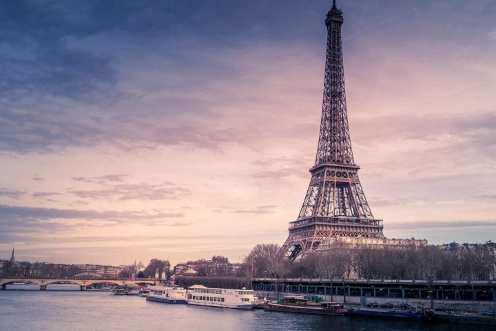 a large clock tower towering over a body of water