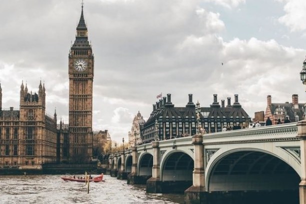 a large bridge over some water in front of a building