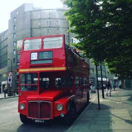 a double decker bus driving down a street