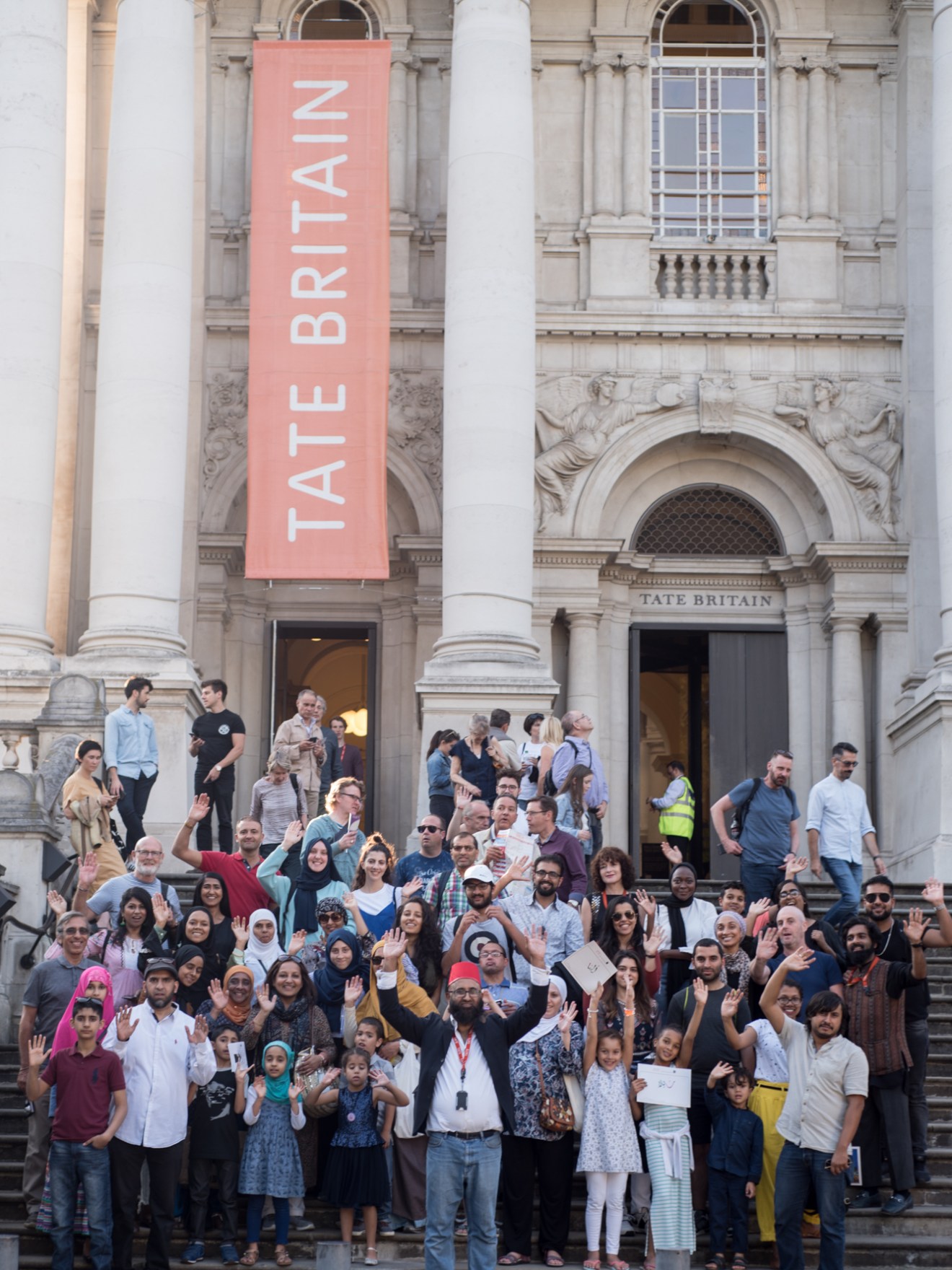 a group of people walking in front of a building