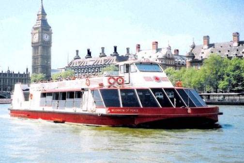 a large boat in a body of water with a city in the background