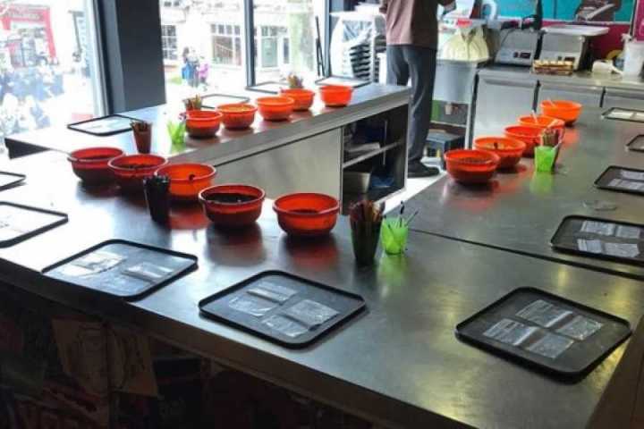 a desk with a laptop computer sitting on top of a counter