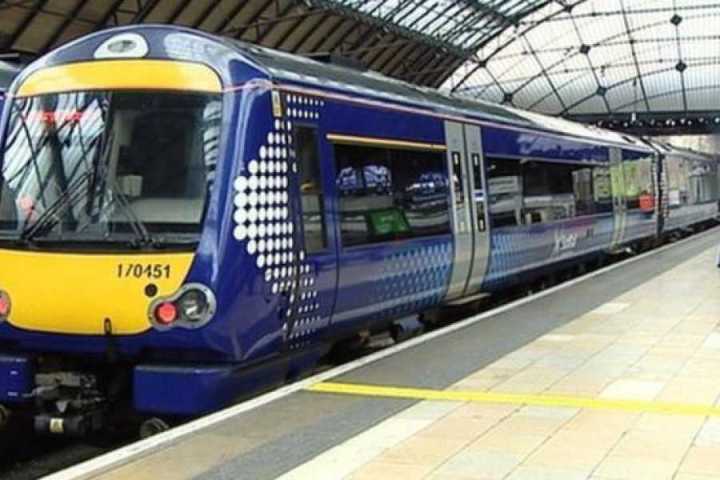 a passenger train pulling into a station