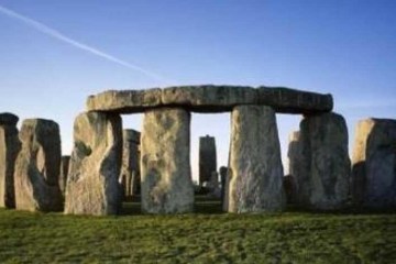 a large stone building with Stonehenge in the background