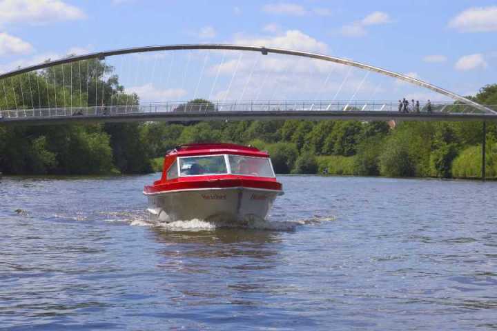 a train crossing a bridge over a body of water
