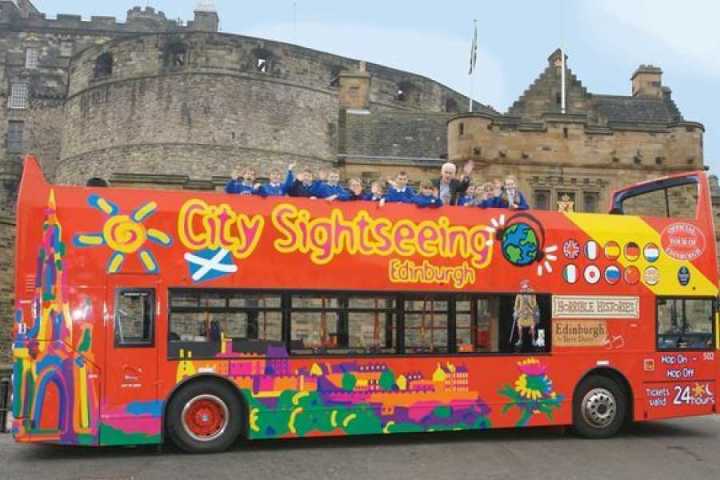 a double decker bus parked on the side of a building