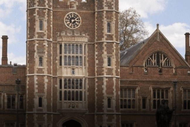 a large clock tower in front of a brick building