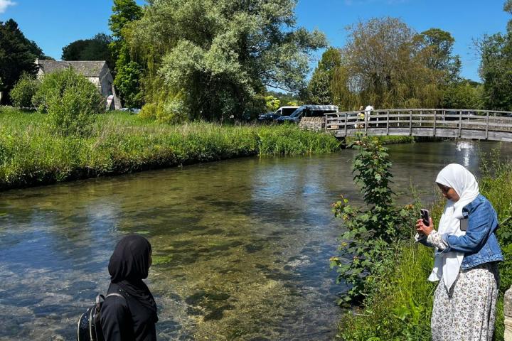a man standing next to a river