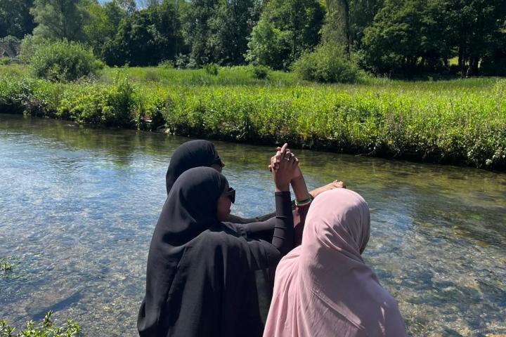 a person standing next to a body of water