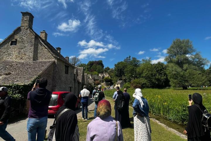 a group of people that are standing in the grass