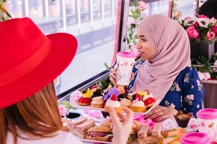 a person sitting at a table with a birthday cake