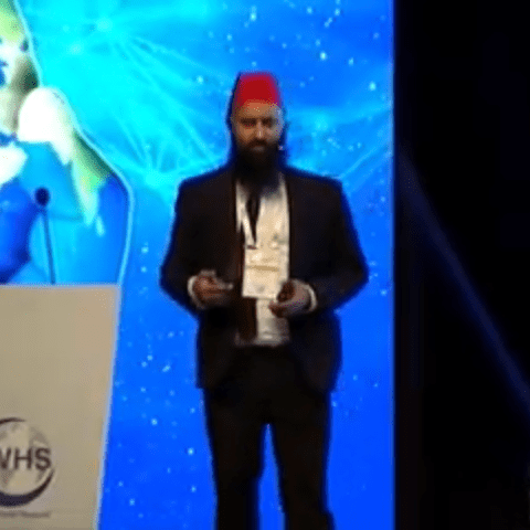 a man standing in front of a flat screen tv