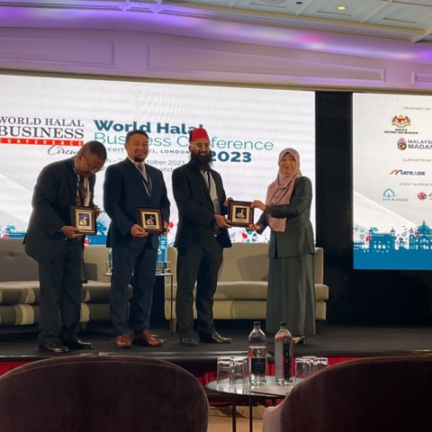 a group of people standing in front of a television