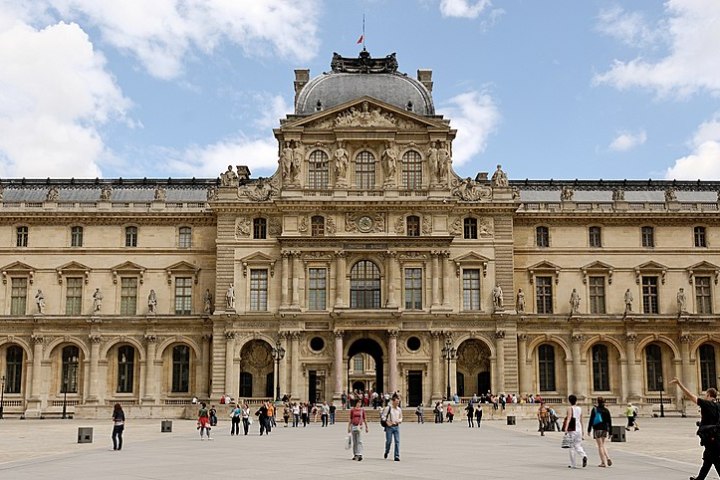 a group of people walking in front of a building
