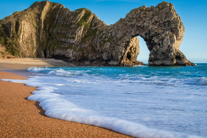 a beach with Durdle Door in the background