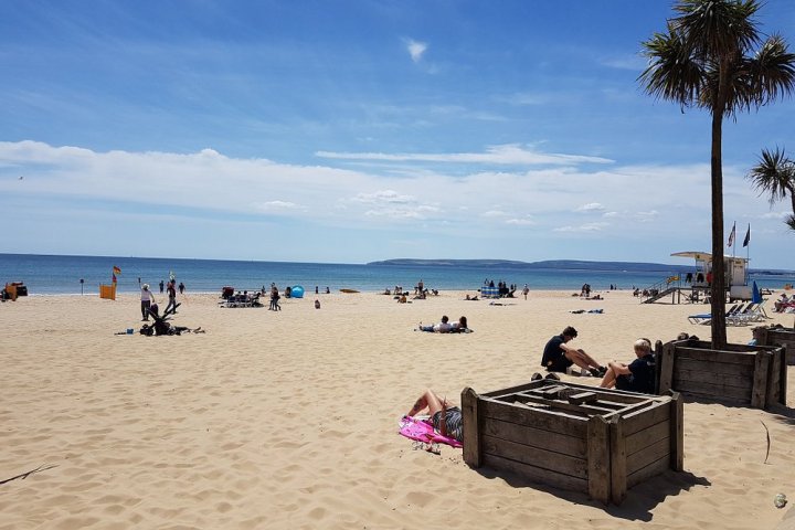 a group of people sitting at a beach